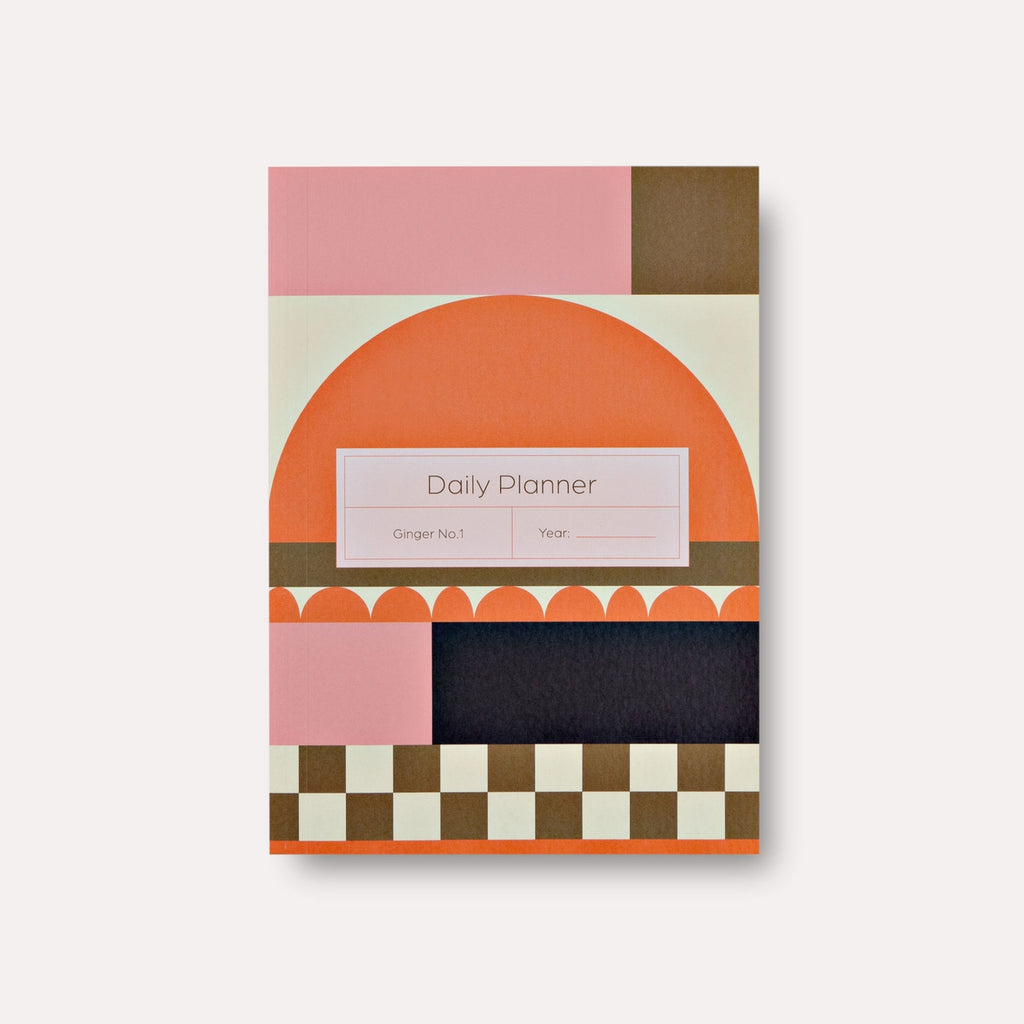 Planner with geometric patterns in orange, yellow, brown and cream.