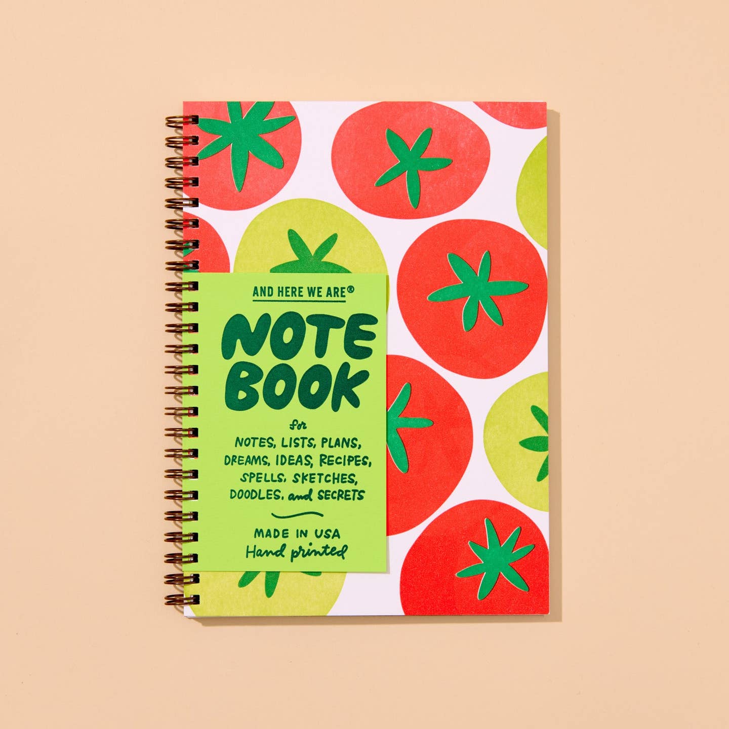 Image of notebook with white background and image of red and green tomatoes with green stems and coiled binding on left side.