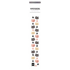 Sticker sheet with images of cat's faces and paw prints in grey, pink and tan. 