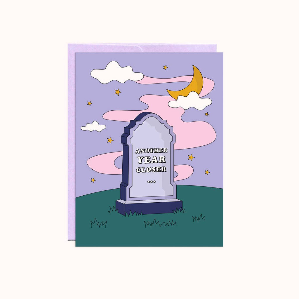 Image of a cemetery headshone with green grass and night sky background with white text says, "Another year closer". Lilac envelope included. 