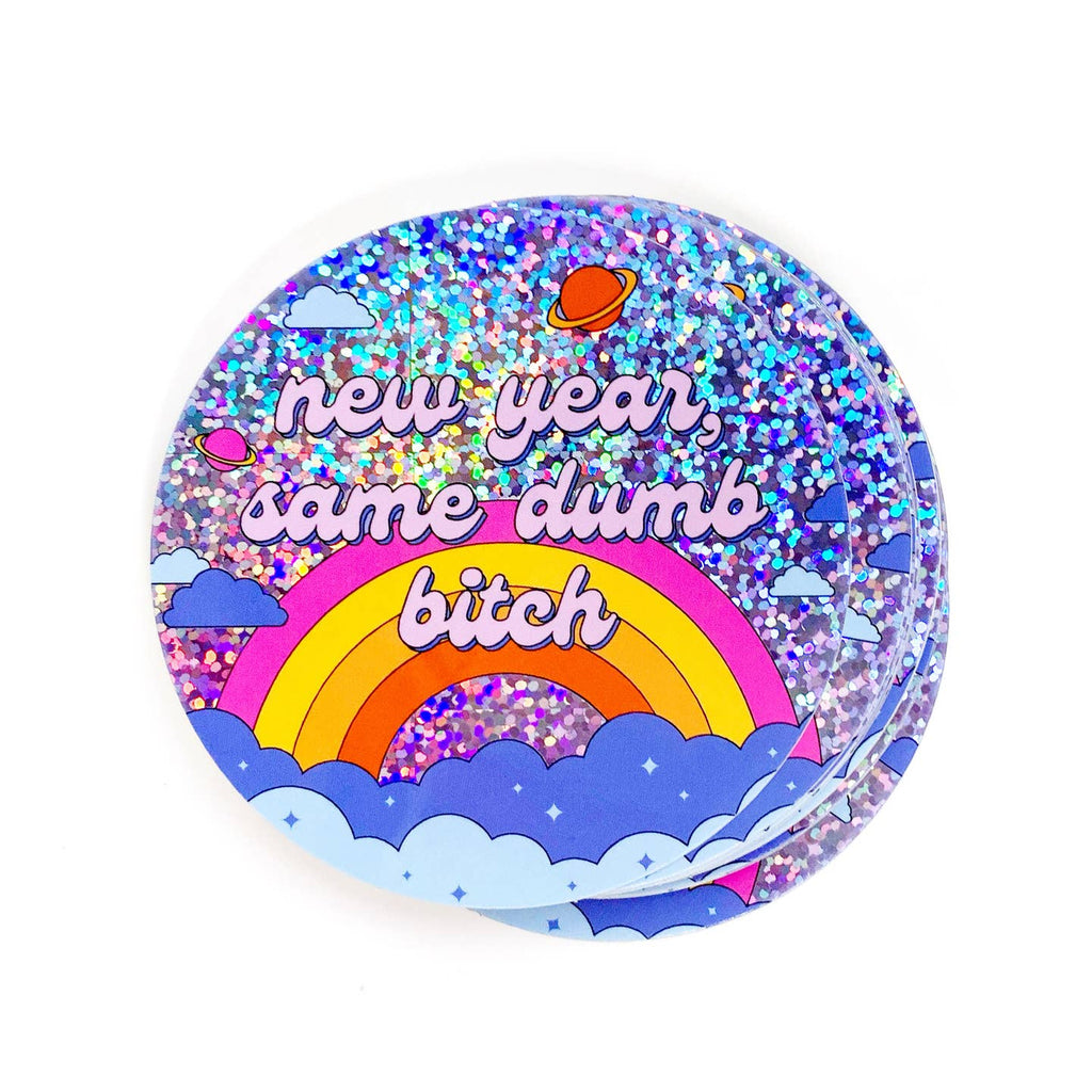 Decorative sticker with holographic background and rainbow and clouds with pink text says, "new year, same dumb bitch". 