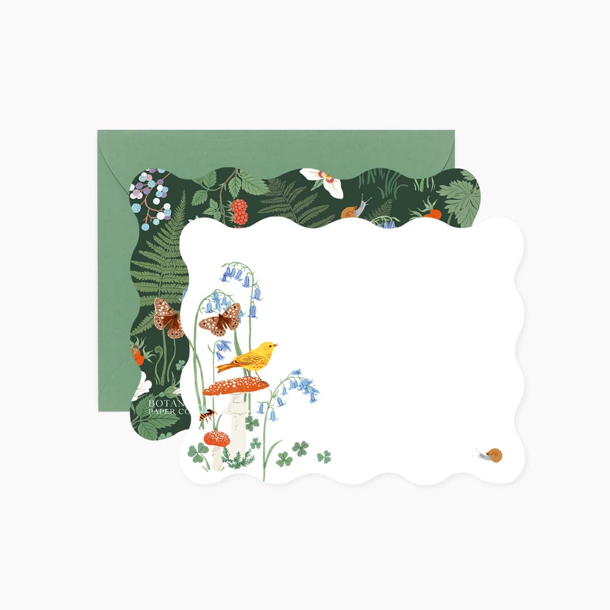 Image of notecard front, back and envelope included. Front has white background with images of red mushroom with yellow bird, blue flowers, and brown butterfly. Back of card has dark green background with images of ferns and flowers.