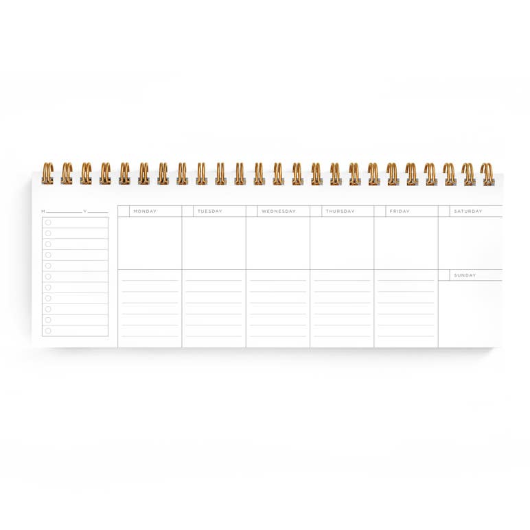 Planner page with white background and lines and black text says, "Monday, Tuesday, Wednesday, Thursday, Friday, Saturday, Sunday". Gold coil binding at top. 