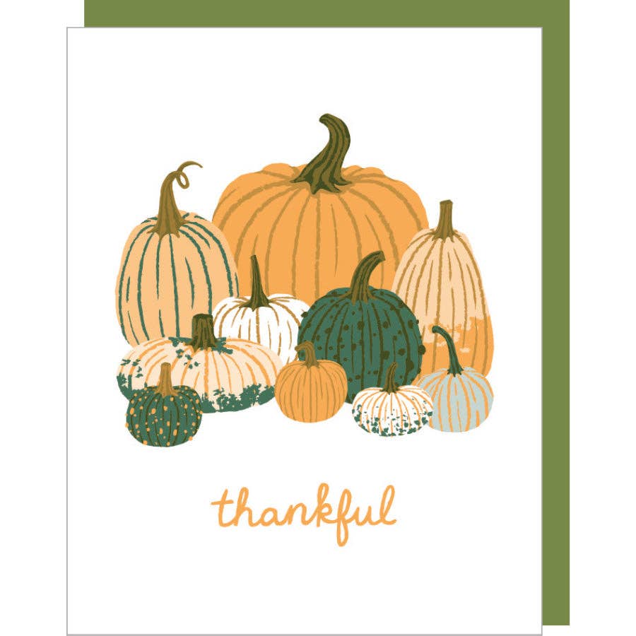 Greeting card with white background and image of group of pumpkins in orange, cream, green and peach. Orange text says, "thankful". Green envelope included. 