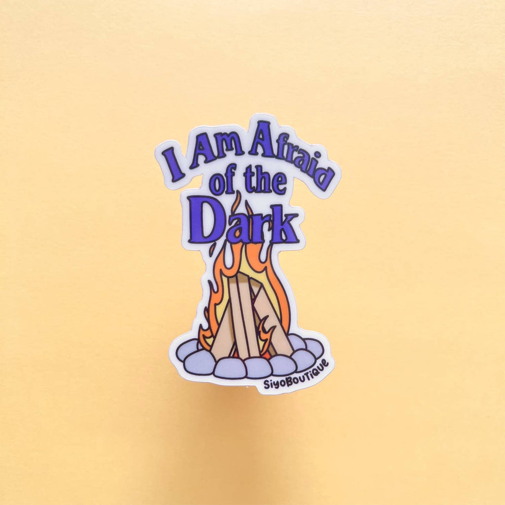 Image of a campfire with purple text says, "I am afraid of the dark". 