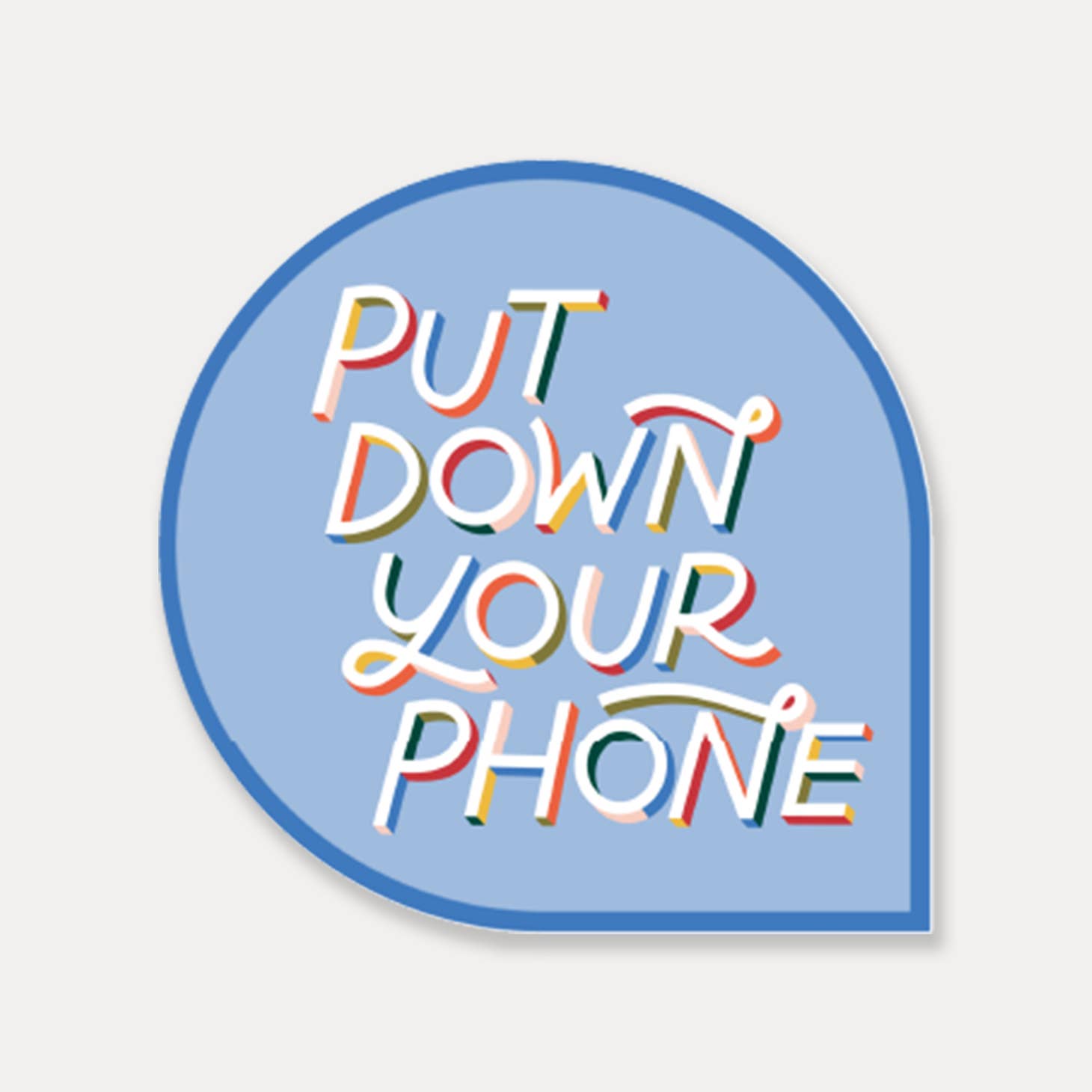 Image of teardrop shaped sticker with light blue background and dark blue border with white text says, "Put down your phone". 
