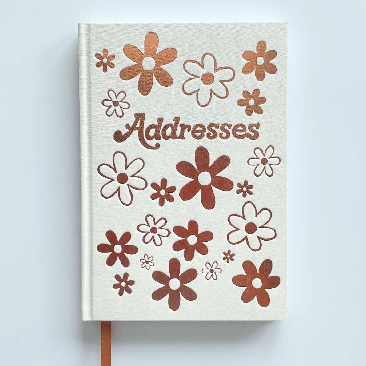 White background cover with images of rose gold flowers and text says, "Addresses".