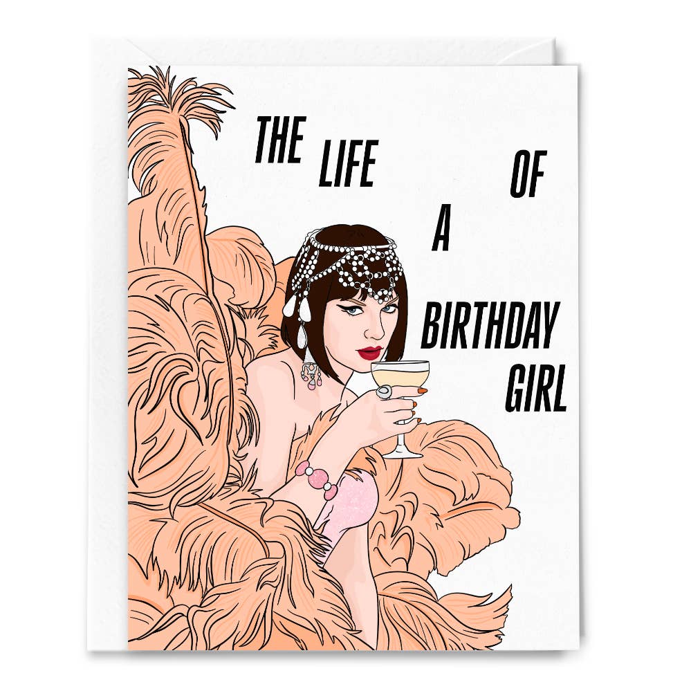 Greeting card with white background and image of Taylor Swift as a showgirl holding a cocktail and black text says, "The life of a birthday girl". Envelope included.