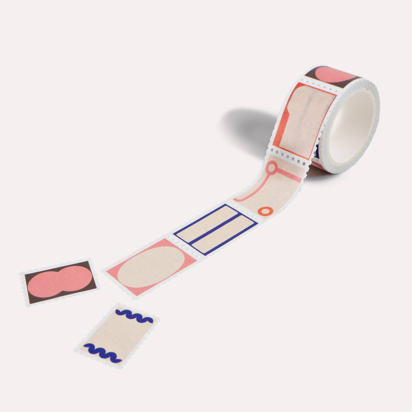 Washi tape with geometric shapes in pink, cream, orange and navy. 