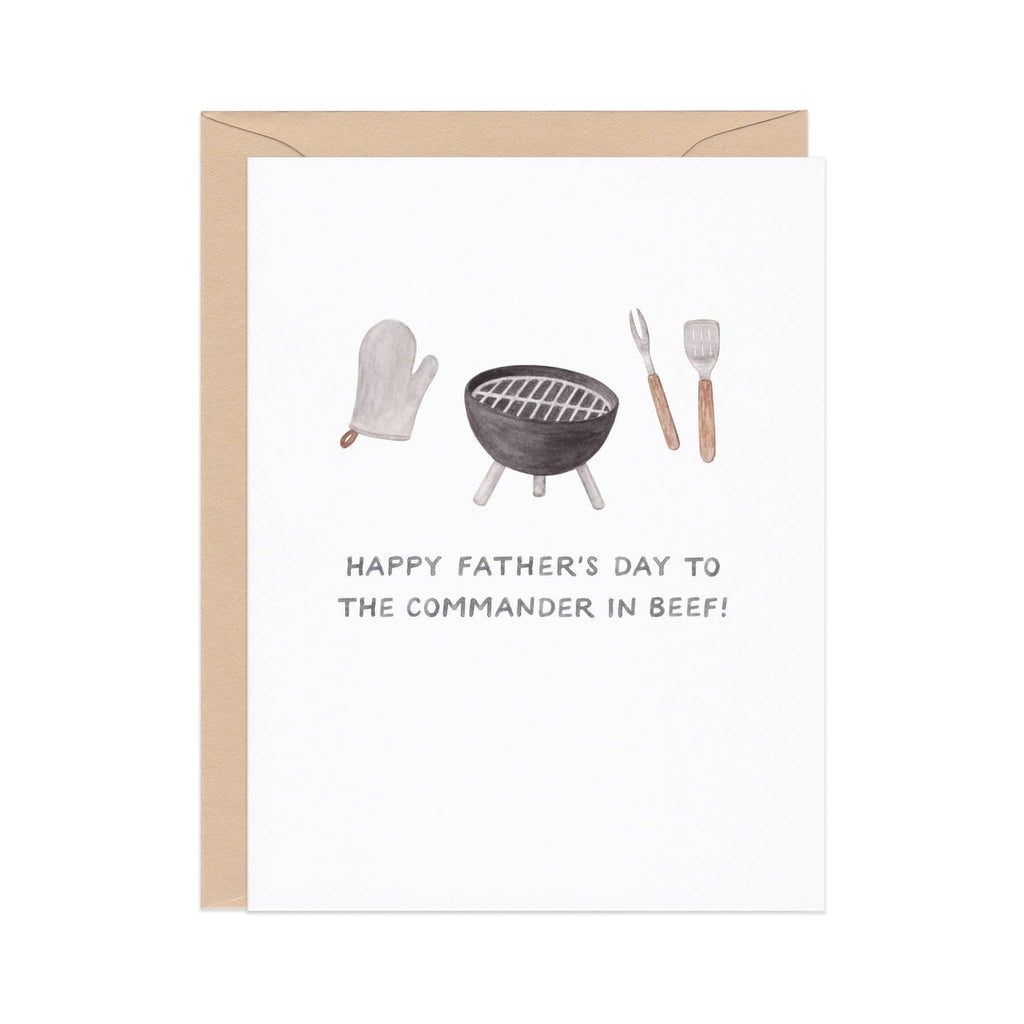Greeting card with white background and image of oven mitt, BBQ grill and grilling utensils with black text says, "Happy Father's Day to the commander in beef!". Kraft envelope included. 