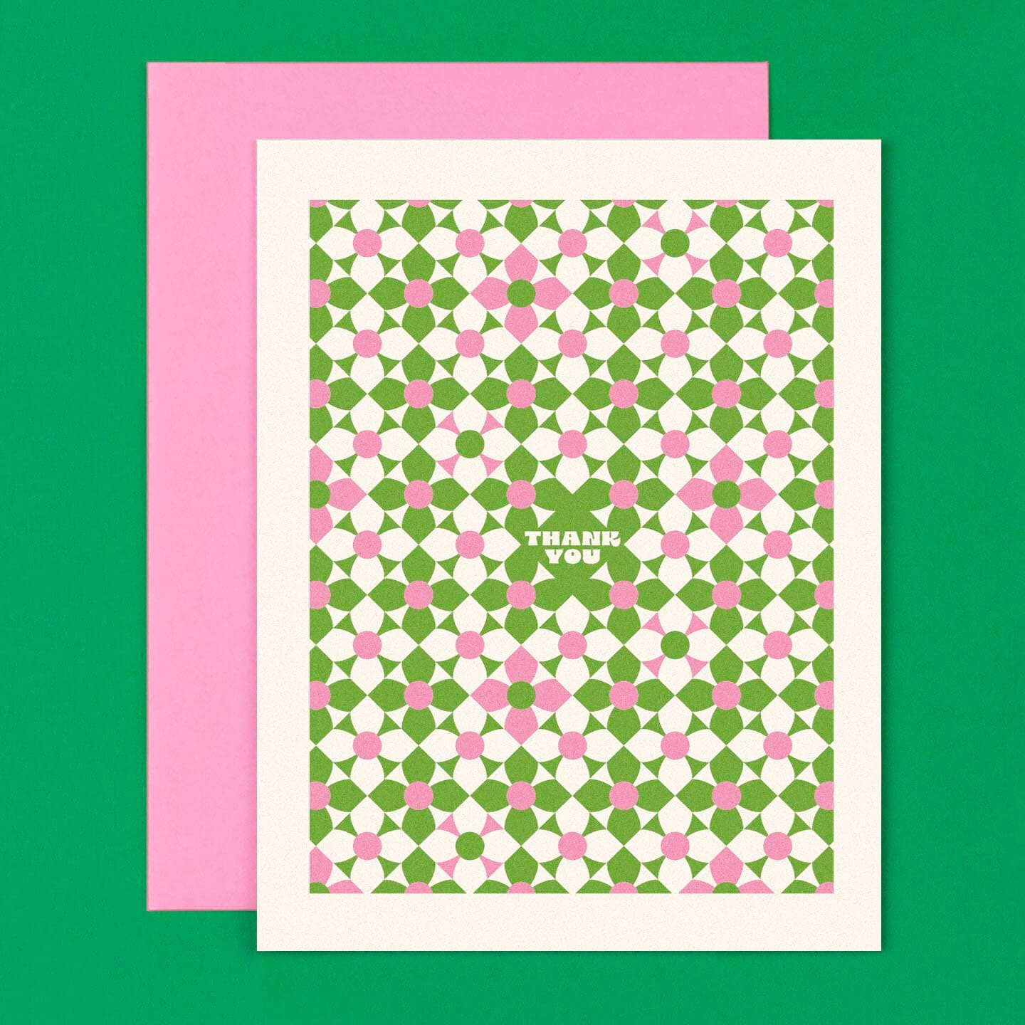 Greeting card with background of green, pink and white modern flowers with white text says, "Thank you" in center of card. Pink envelop included. 