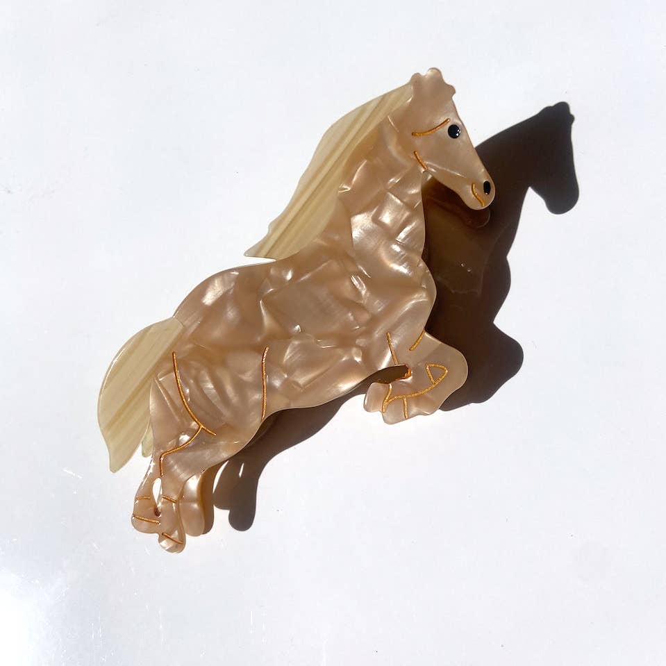Image of horse hair clip in brown with beige mane and tail and gold detailing. 