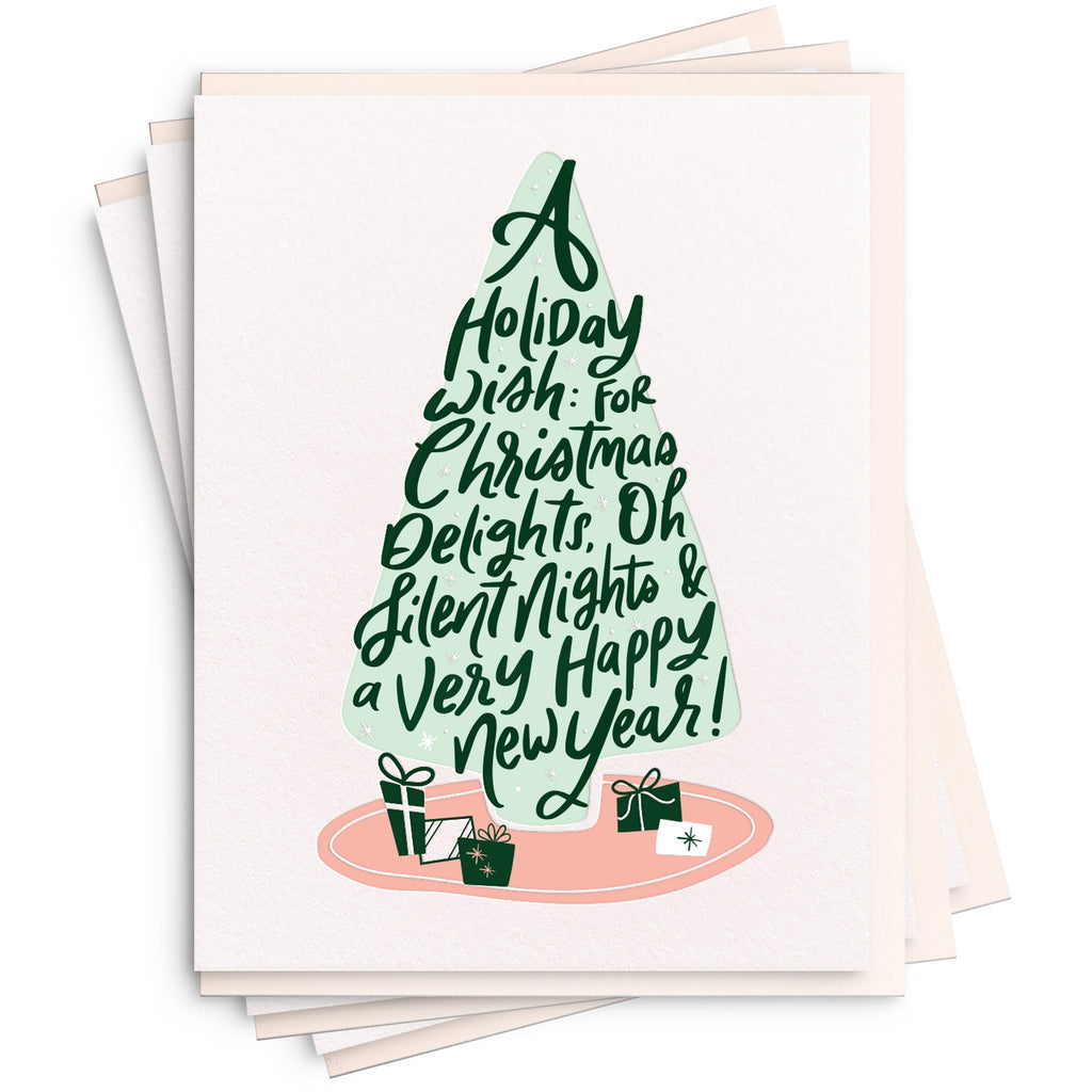 Greeting cards with white background and green holiday tree with pink tree skirt and green text says, "A holiday wish: for Christmas delights, oh silent nights & a very happy New Year!". White envelopes included. 