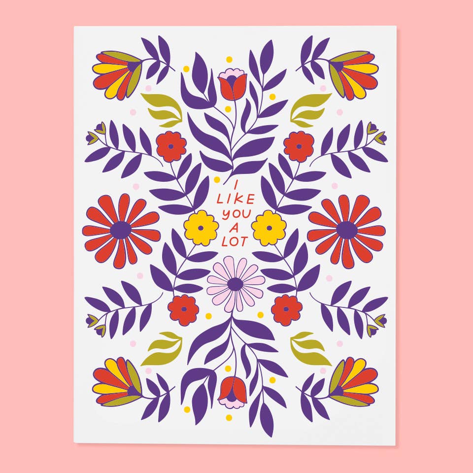 Greeting card with white background and images of flowers in purple, red, green yellow and pink. Red text says, "I like you a lot". Envelope included.