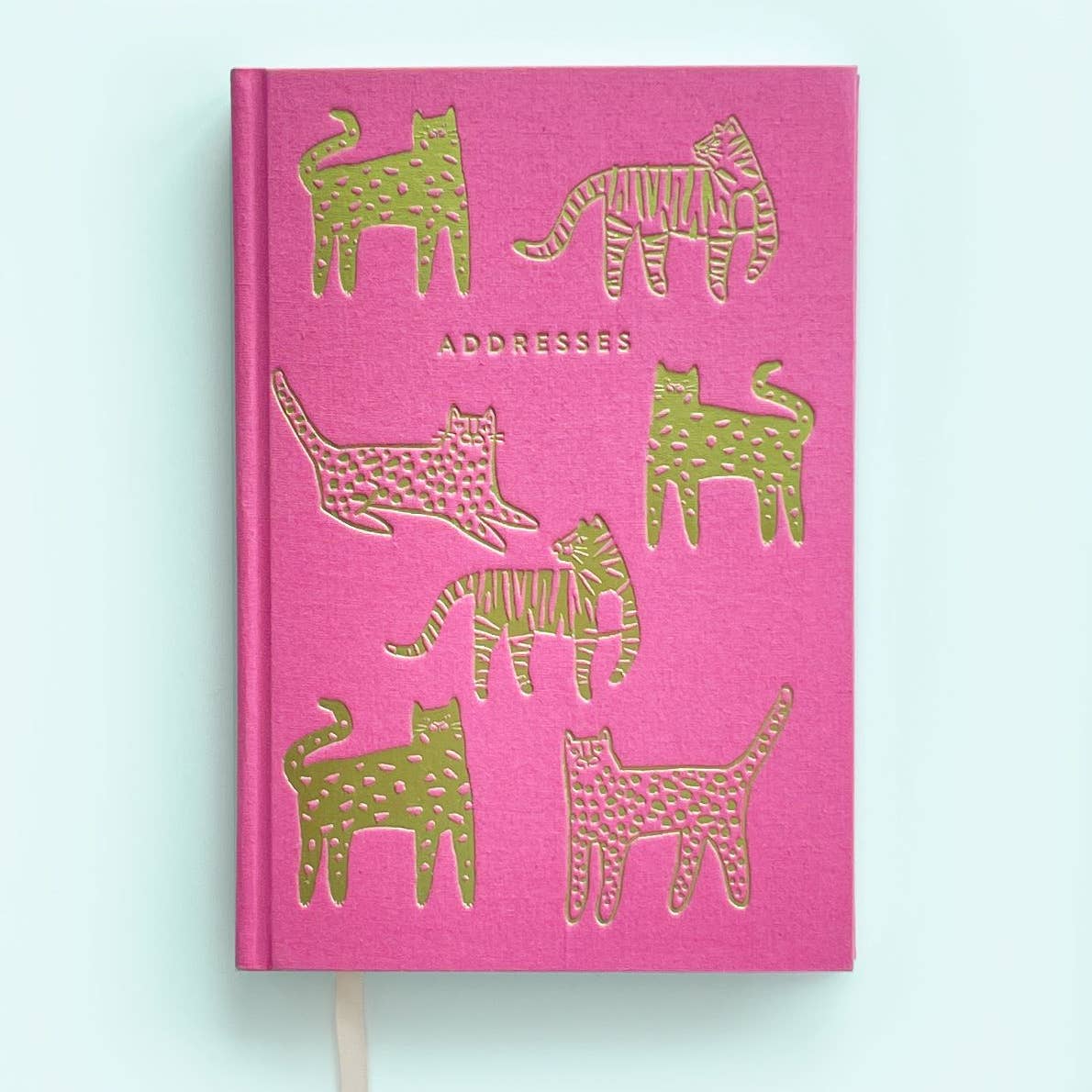 Pink background with images of gold foil tigers and jaguars with gold foil text says, "Addresses".