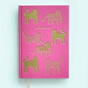 Pink background with images of gold foil tigers and jaguars with gold foil text says, "Addresses".