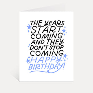 Greeting card with white background and black and blue text says, "The years start coming and they don't stop coming Happy Birthday!". Envelope included. 