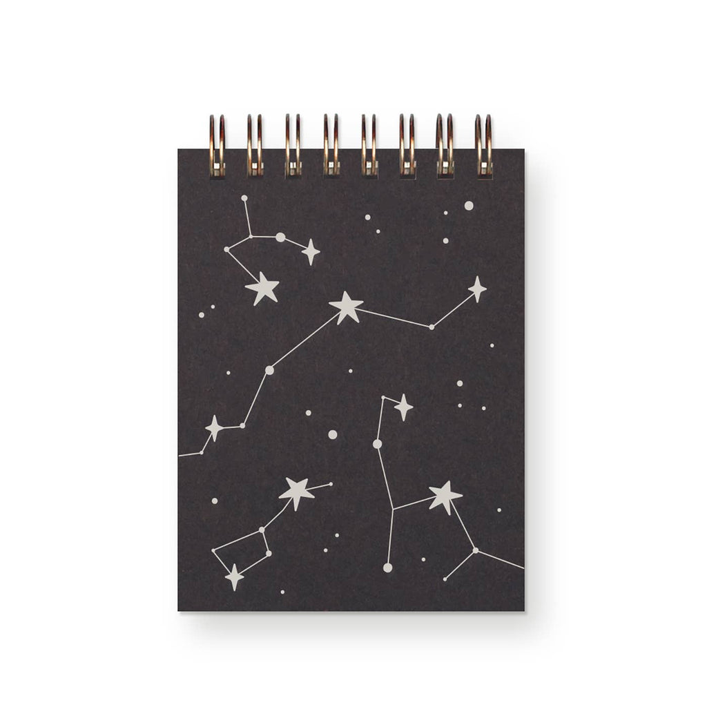 Notebook cover with black background and silver constellation designs.