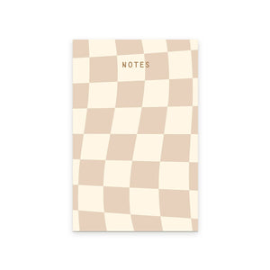 Notepad with cream and tan wavy checkerboard pattern with gold text says, "Notes". 