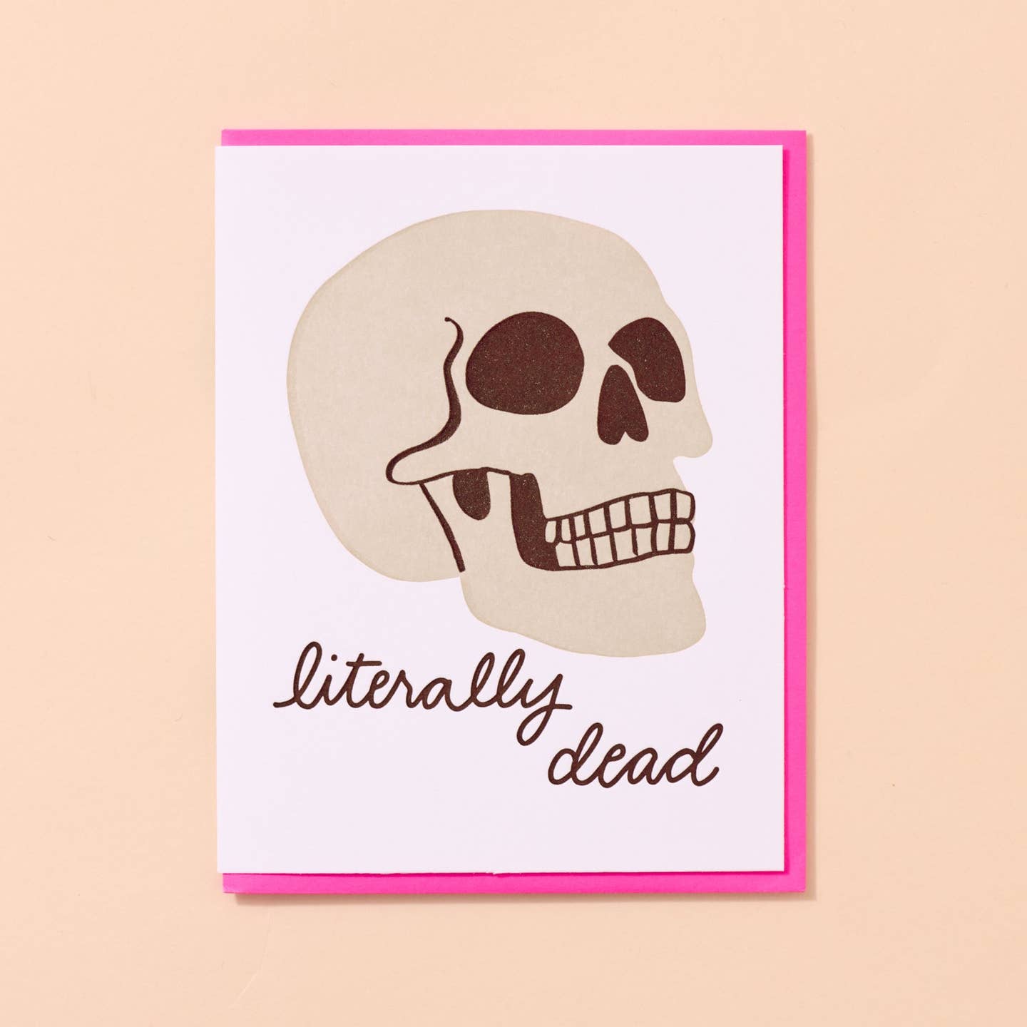 Greeting card with white background and image of a skull with black text says, "Literally dead'. Hot pink envelope included. 