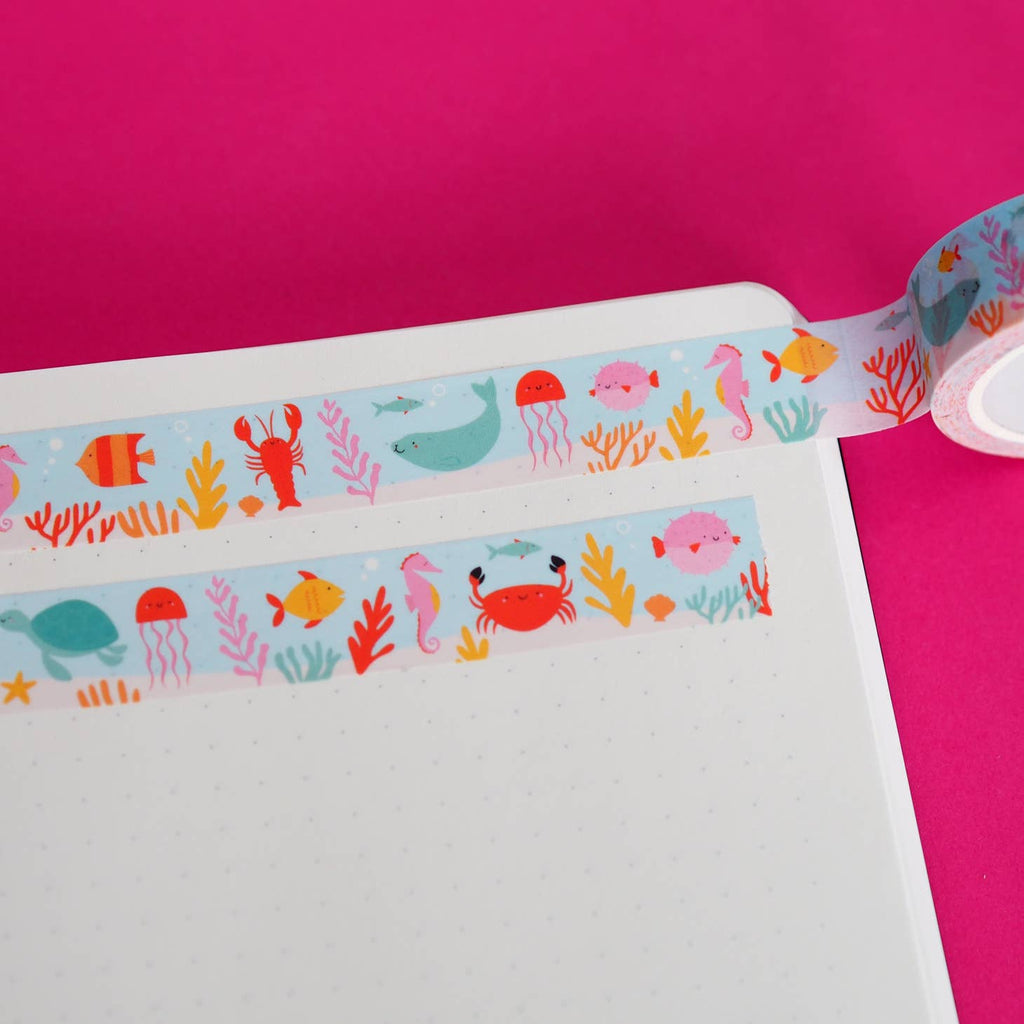 Image of Washi tape with aqua and white background with images of lobster, fish, seals and seahorses.