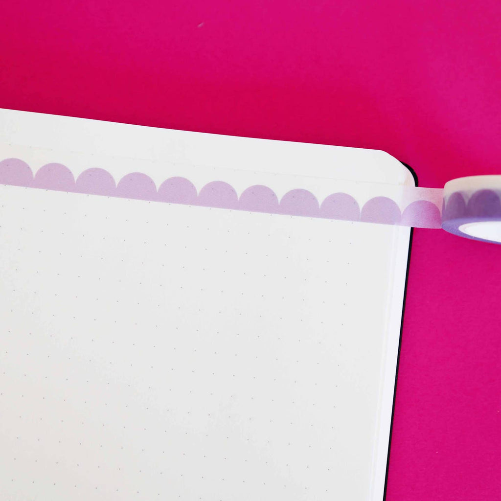 Washi tape with lilac scalloped pattern edged in white.