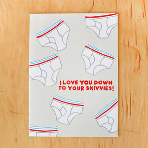 Greeting card image with light grey background with images of white mens underwear with red and blue striped waistband and red text says, "I love you down to your skivvies!". Envelope included. 