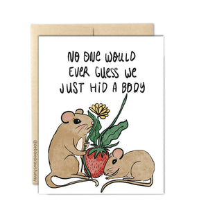 White background with image of two mice with a strawberry and a flower and black text says, "No one would ever guess we just hid a body". Kraft envelope included. 