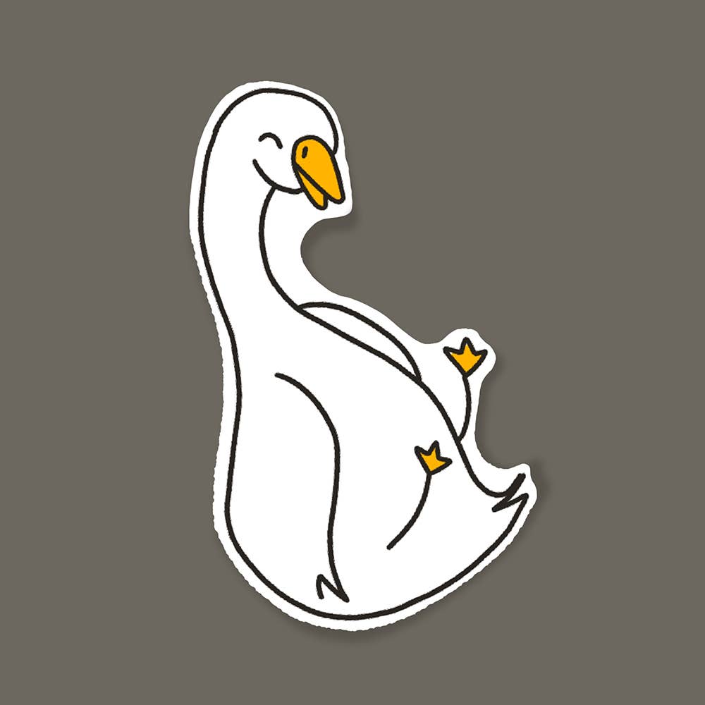 Image of a white goose with orange beak and feet  sliding.