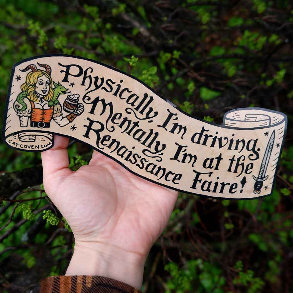 Decorative sticker with tan background and black text says, "Physically I'm driving. Mentally, I'm at the Renaissance Faire!".