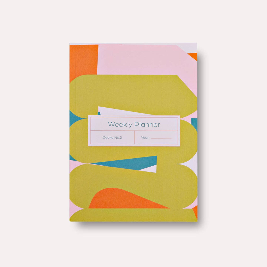 Planner cover with pink, orange, chartreuse and teal geometric pattern.