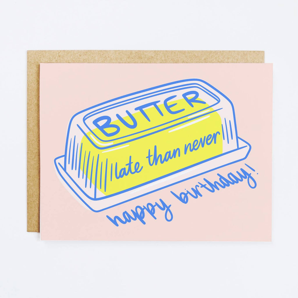 Pink background with image of butter in a glass butter dish with blue text says, "Butter late then never, happy birthday!". Kraft envelope included.