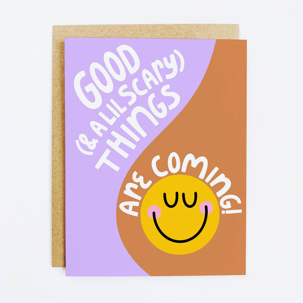 Lilac and brown background with yellow smiley face and white text says, "Good (& a lil scary) things are coming!". Kraft envelope included. 