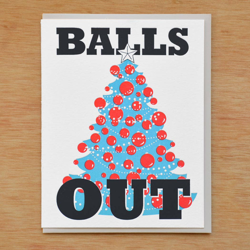 Greeting card with white background and image of a blue tree with red balls on it and a white star. Black text says, "Balls out". Envelope included. 