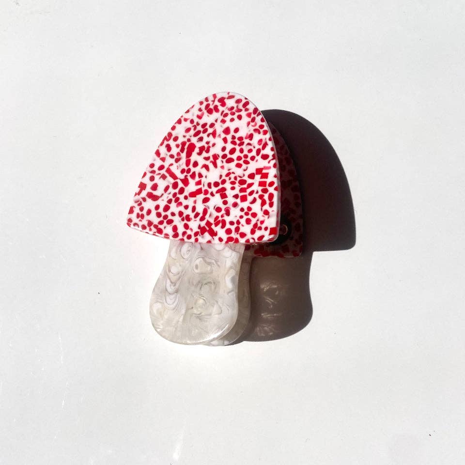 Image of toadstool with cream background with red flecks and white stalk. 