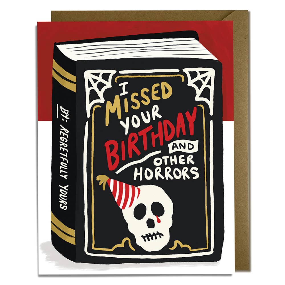 Greeting card with black background in an image of a book with a white skull wearing a red and white party hat and spiderwebs at the corners. White, gold and red texts says, "I miss your birthday and other horrors", "by: Regretfully yours". Kraft envelope included. 