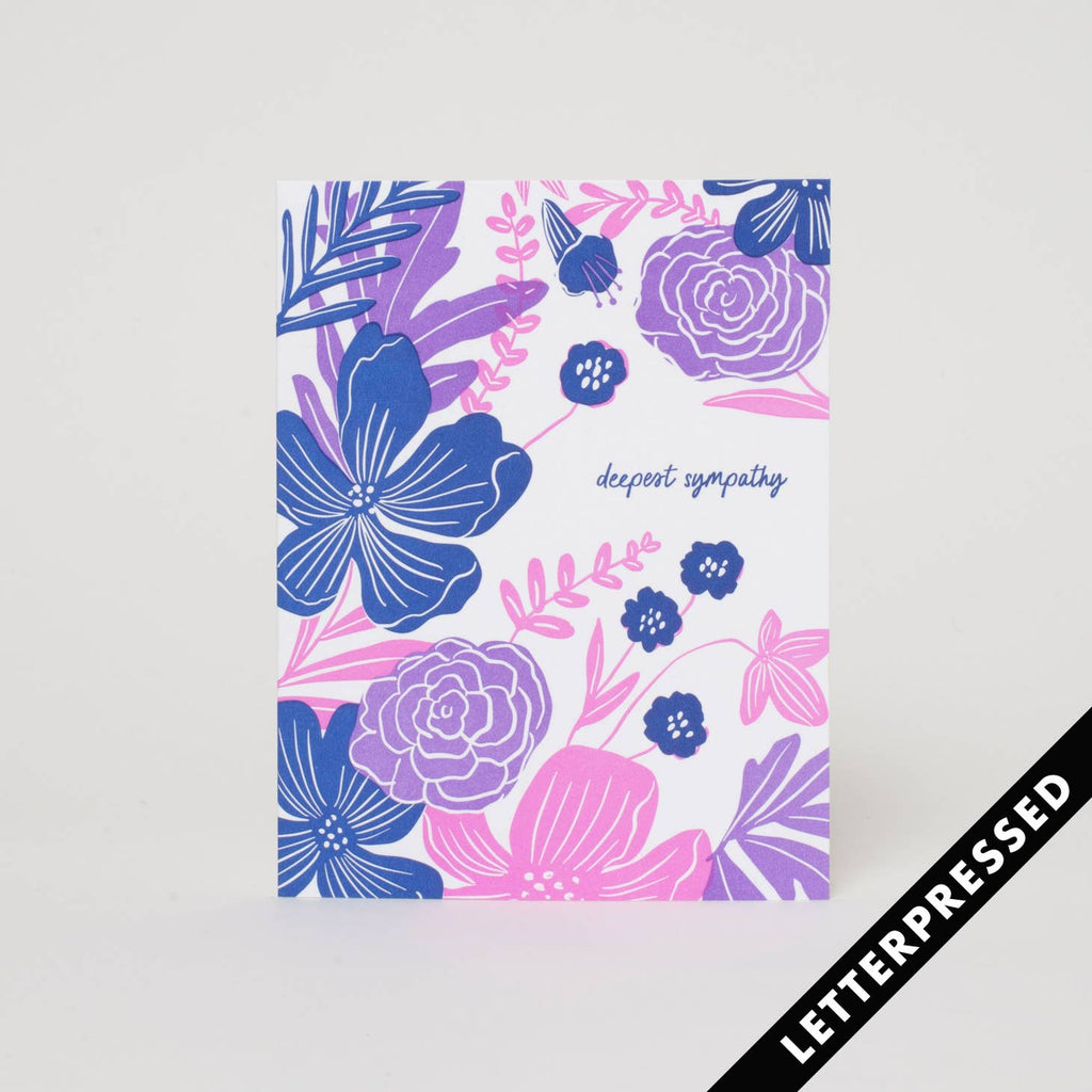 White background with image of purple, blue and pink flowers and blue text says, "deepest sympathy". Kraft envelope is included. 