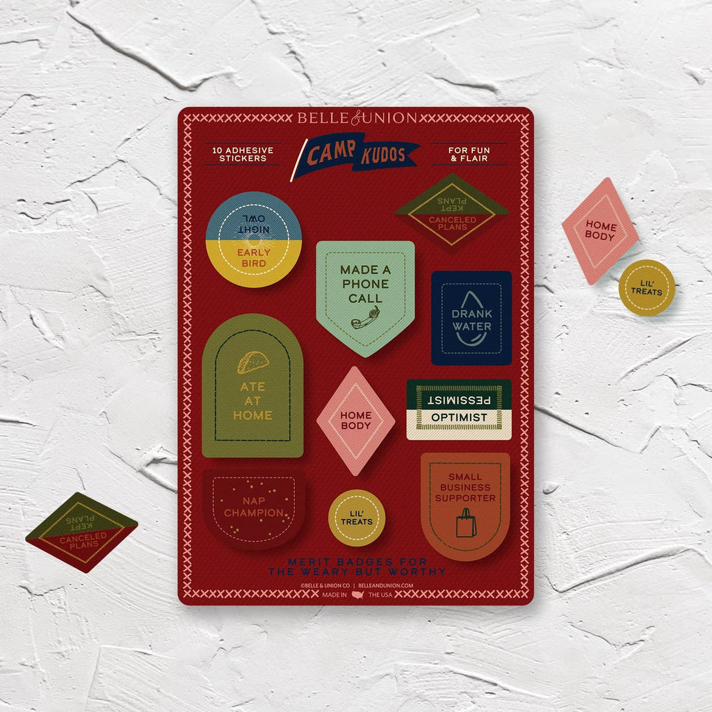 Sticker sheet with burgundy background and stickers with adult merit badges including "made a phone call, Home body, Drank water, Lil' treats".