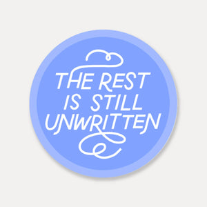 Decorative sticker with blue background and white text says, "The rest is still unwritten". 