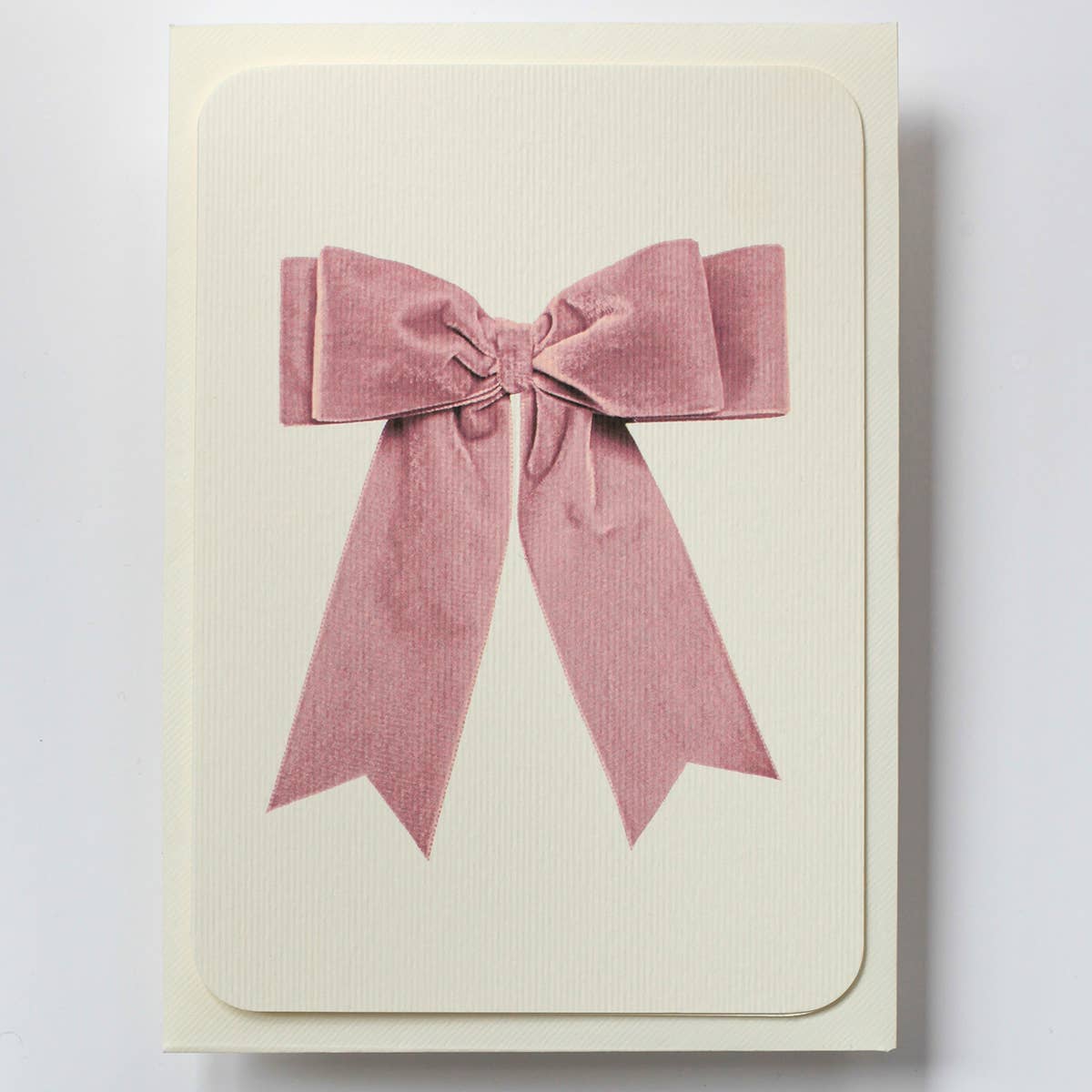 Greeting card with image of a pink velvet bow on cream background. Envelope included.