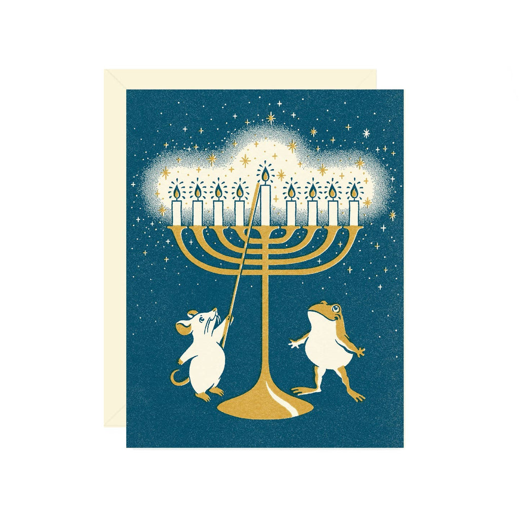 Greeting card with blue background and image of a frog and a mouse lighting a menorah. Envelope included.
