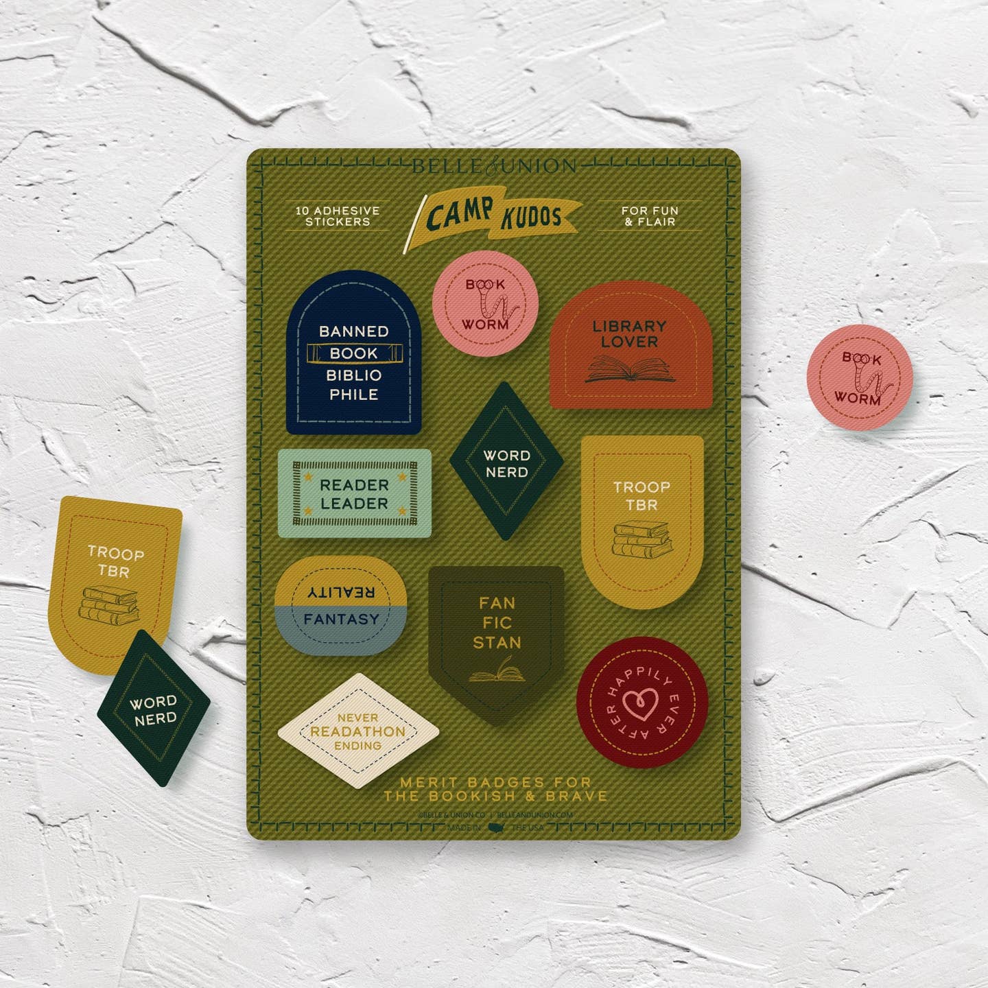 Sticker sheet with olive background and sticker with book themes sayings, "Word nerd, Troop TBR, Fanficstan, Bookworm".