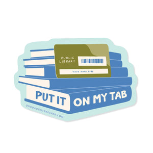 Decorative sticker with image of a stack of blue books with a green public library card and blue and white text says, "Put it on my tab". 