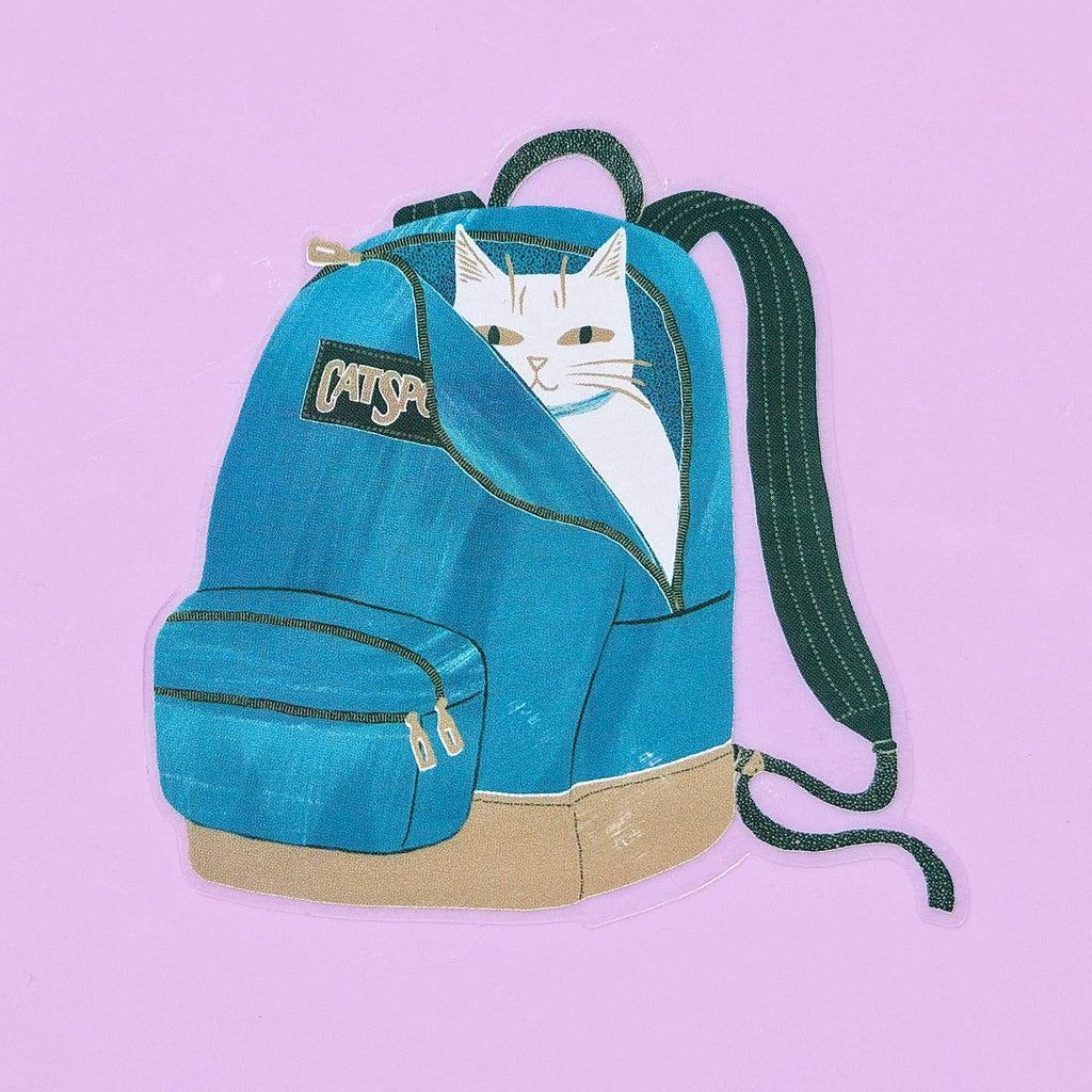 Decorative sticker in image of a white cat hiding inside a blue backpack.