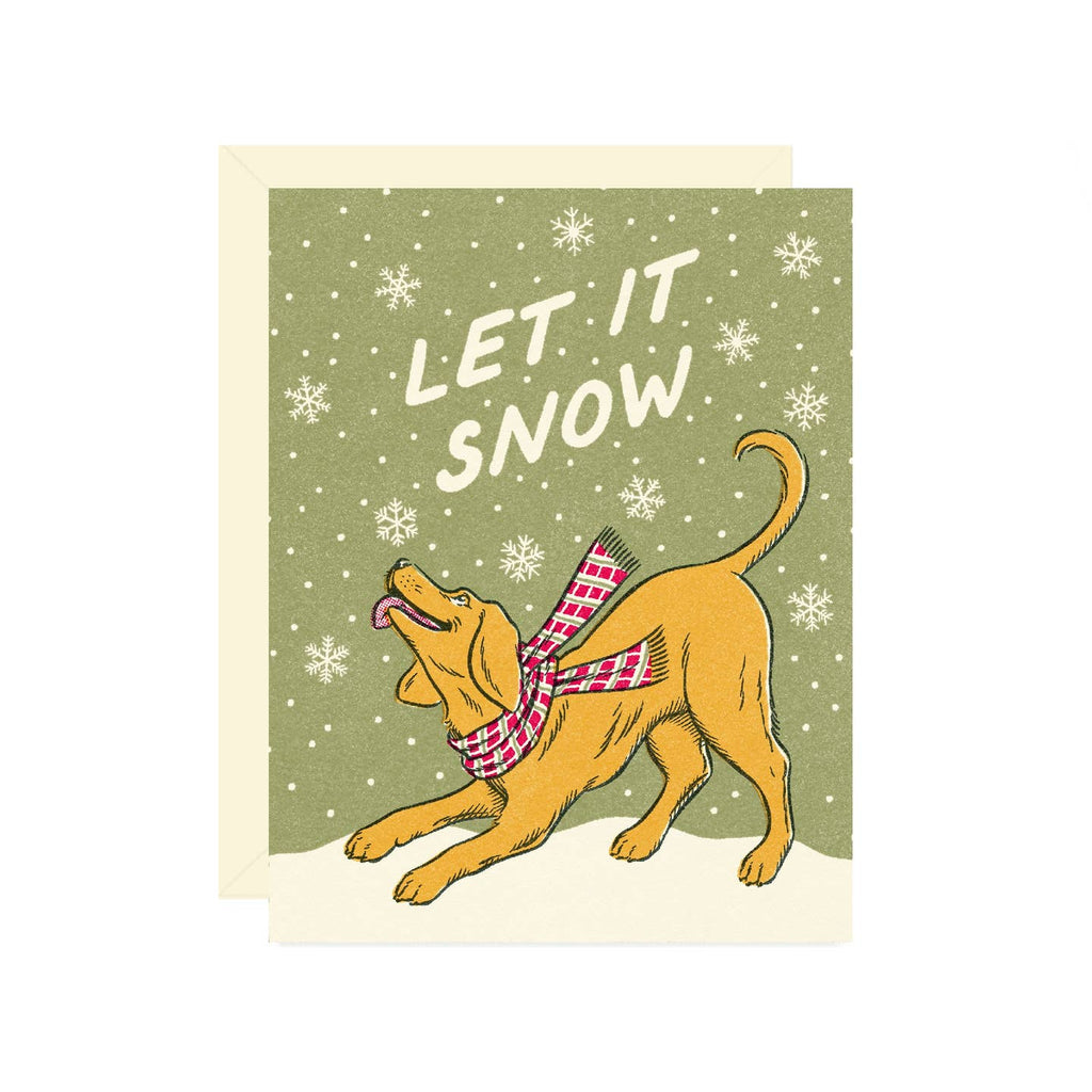 Greeting card with green background and white snowflakes with image of a dog wearing a plaid scarf and white text says, "Let it snow". Envelope included.