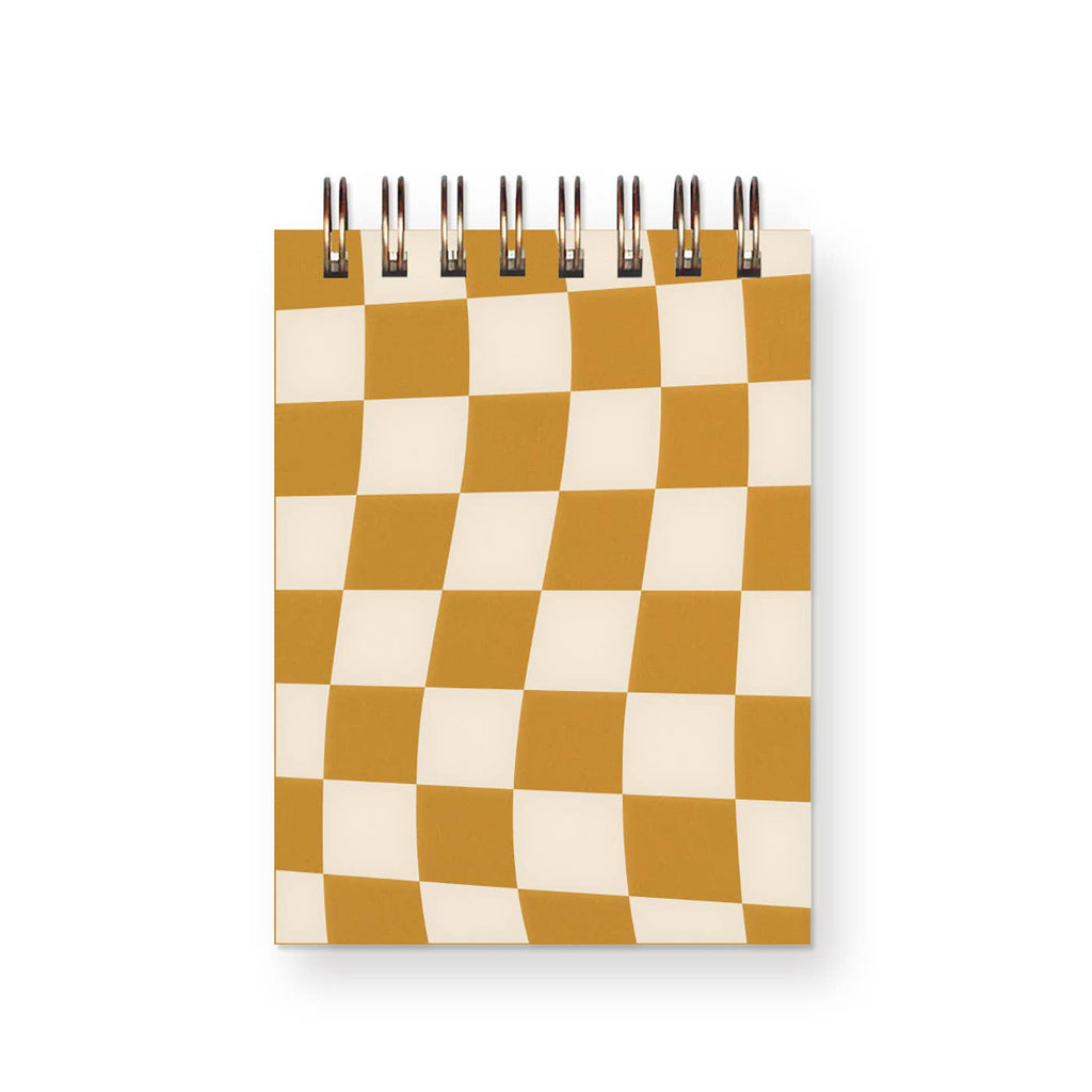 Notebook with saffron and white checkerboard pattern on cover and coil binding at top. 