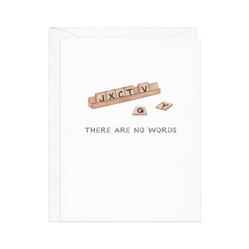 Greeting card with white background and image of a set of Scrabble tiles on a holder with black text says, "J X C T V Q Y" and "There are no words". Envelope included.