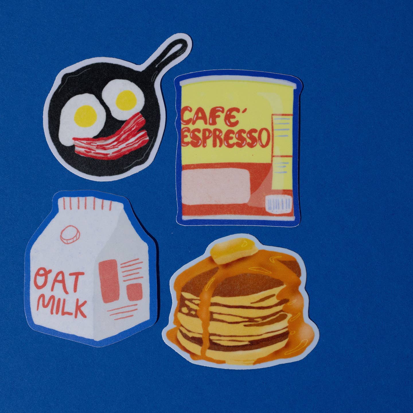 Package of decorative stickers in the image of pancakes, cafe expresso, oat milk and a skillet with eggs and bacon.