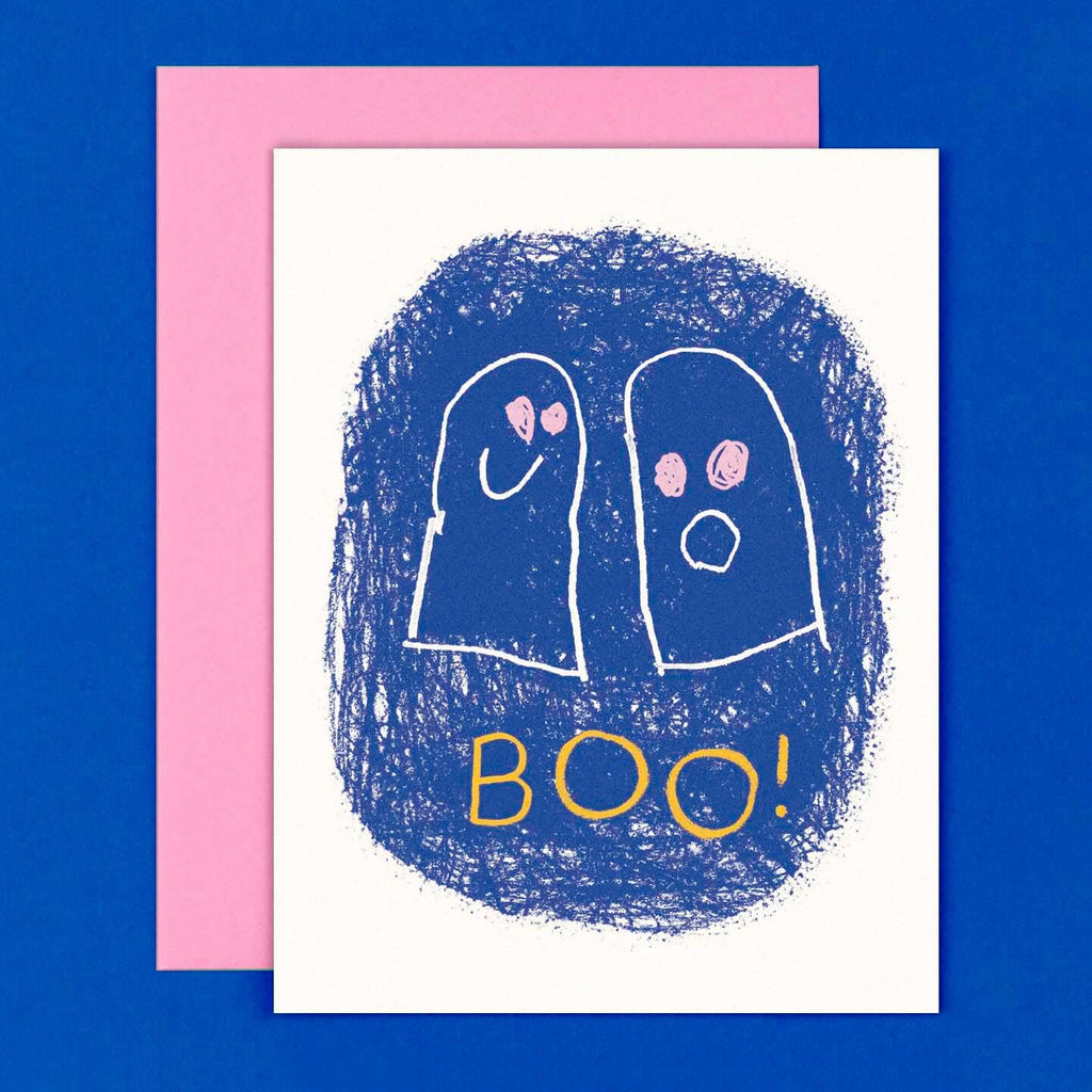 Greeting card with white background and blue oval with two drawn ghosts with pink eyes and yellow text says, "Boo!". Pink envelope included. 