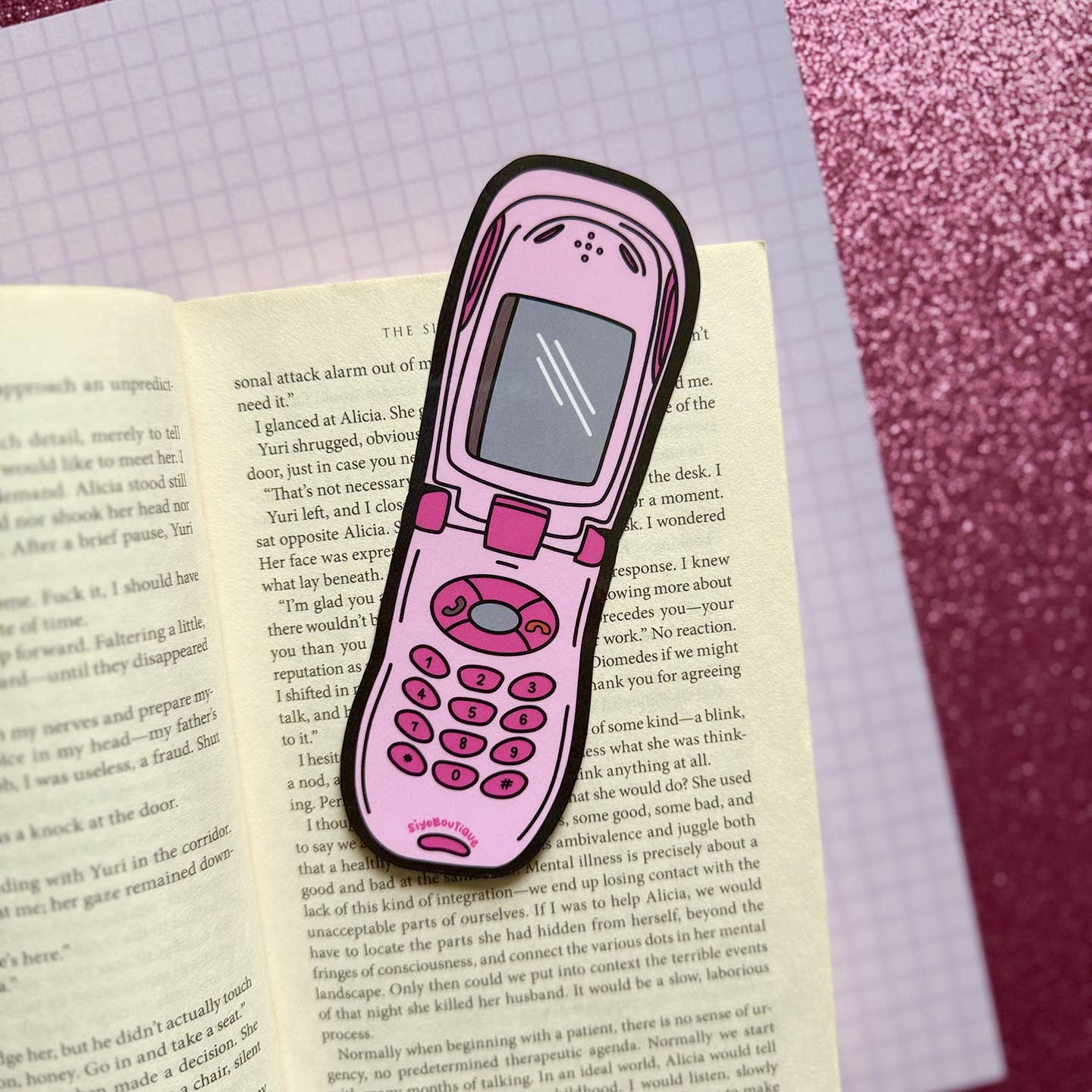 Bookmark in the image of a pink flip phone with bright pink buttons. 